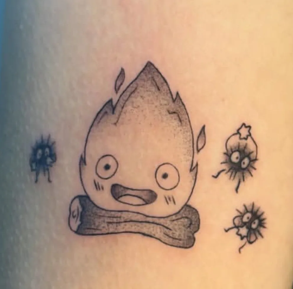 Fine-line Studio Ghibli fire spirit Calcifer with soot sprites on skin
