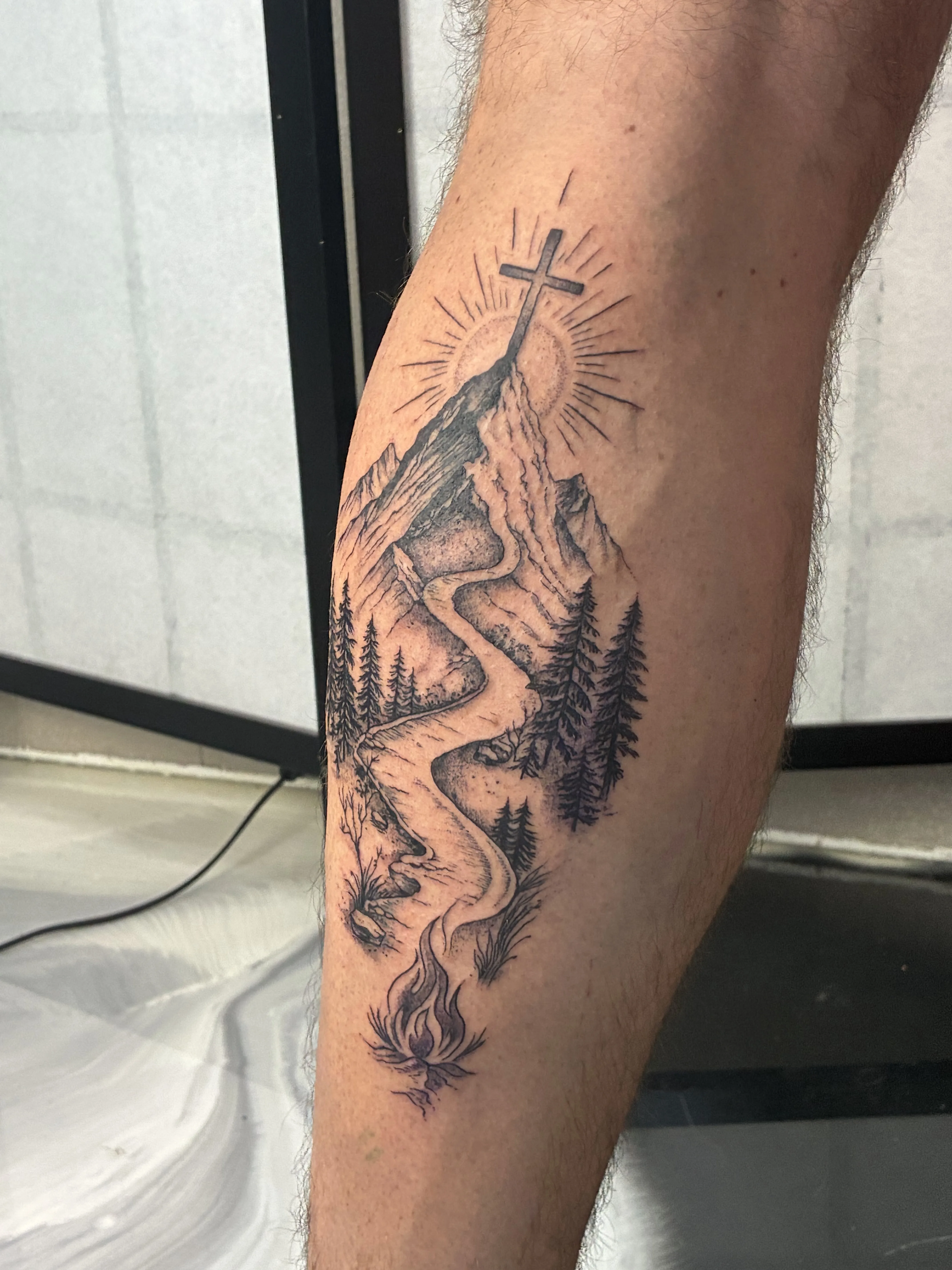 Fine-line mountain, cross, winding river and pines landscape on a calf
